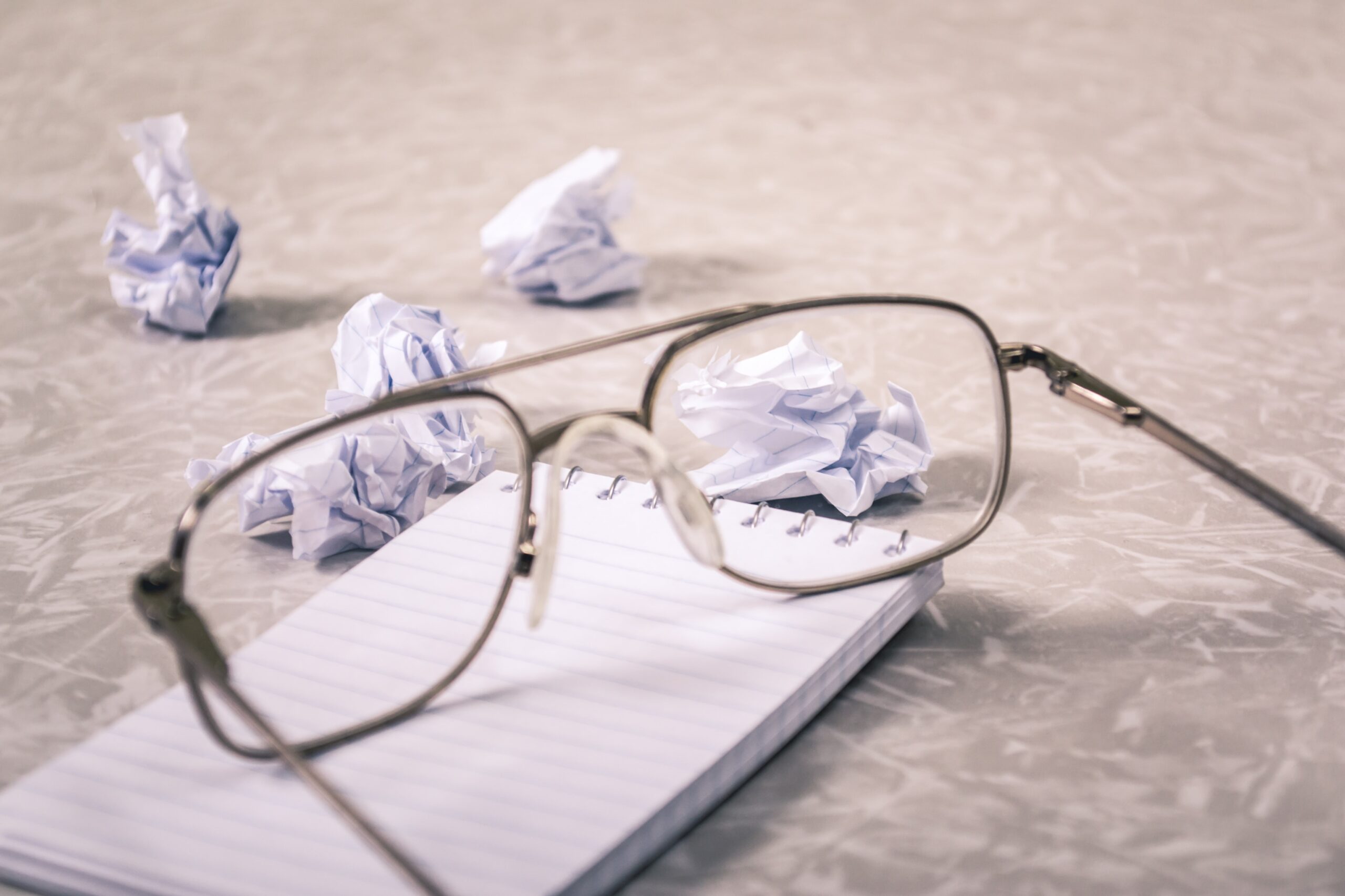 crumpled resumes and glasses